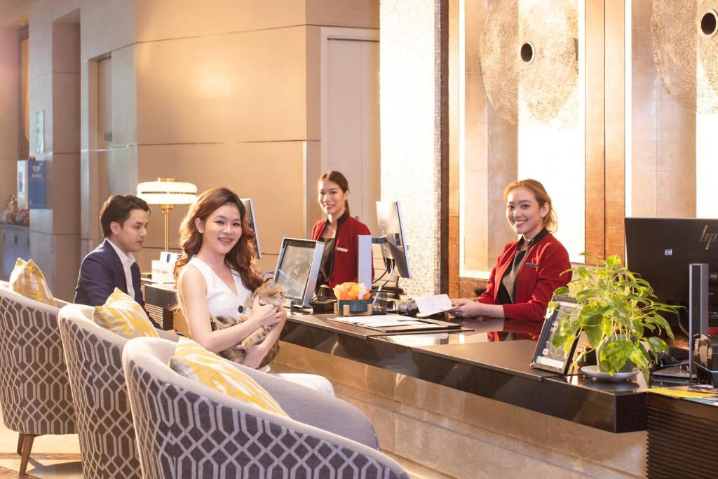 A staffed reception desk with lounge chairs for arrivals and check-in.