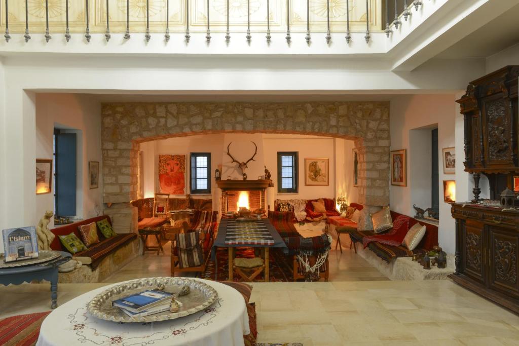 a large living room with a fireplace and a table at Dar Chennoufi in Sicca Veneria