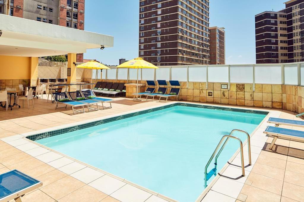 a swimming pool on top of a building at The Oceanic 2 Bedroom with Ocean View - Self Catering Apartment in Durban