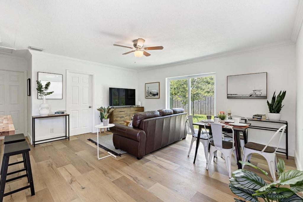 a living room with a couch and a table at Bright and Spacious 2 BR Apartment in Fort Lauderdale