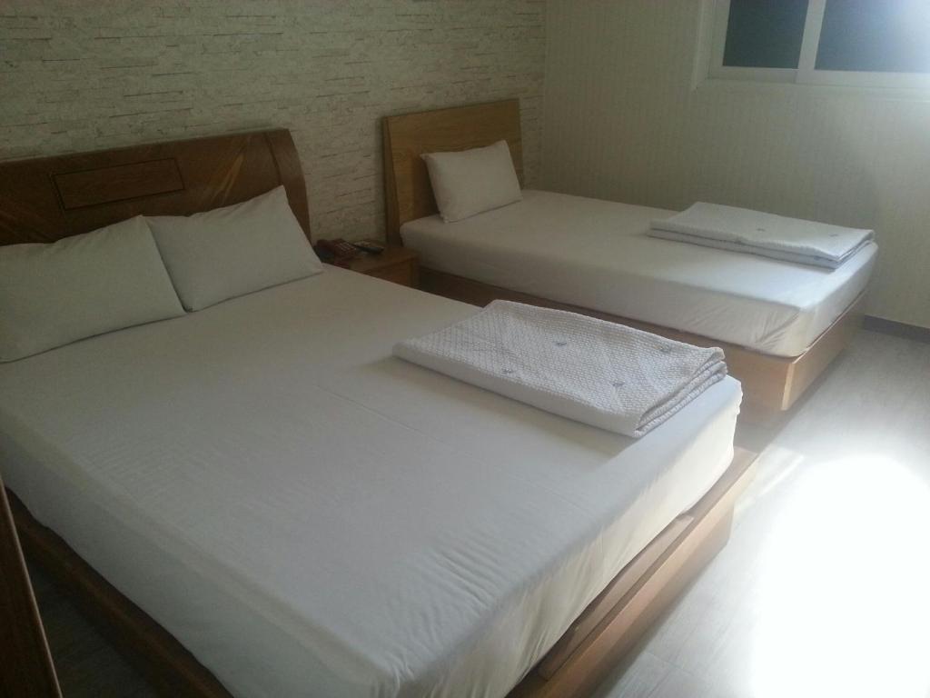 Postel nebo postele na pokoji v ubytování Hansol Hotel