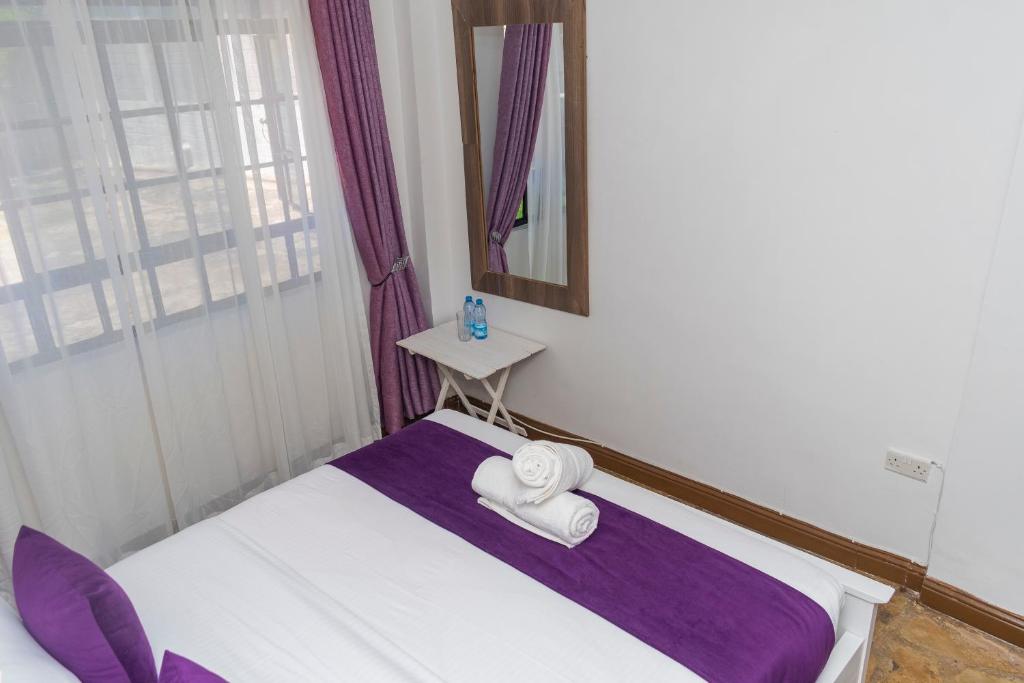Postel nebo postele na pokoji v ubytování Elevate by African Manor