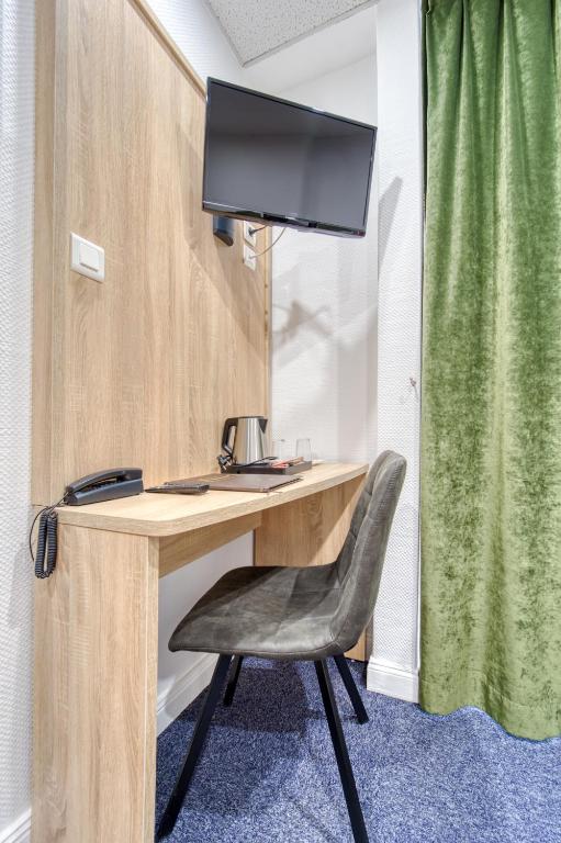 TV a/nebo společenská místnost v ubytování Hôtel Escurial - Centre Gare