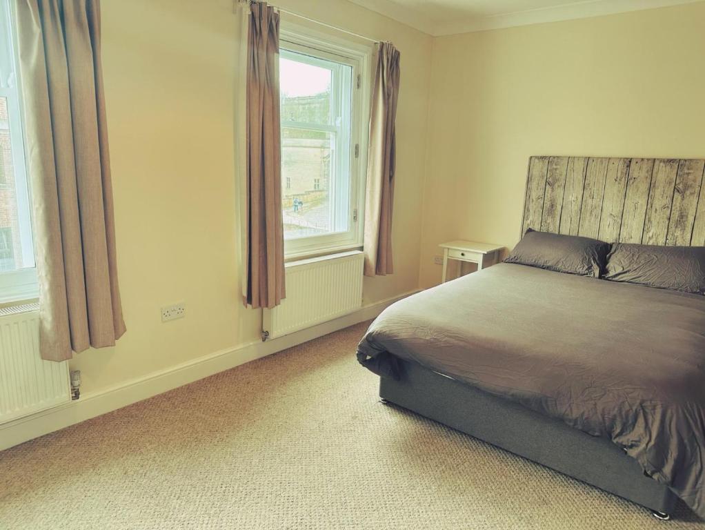 a bedroom with a bed and a window at Castle View, 96 Friar Lane in Nottingham