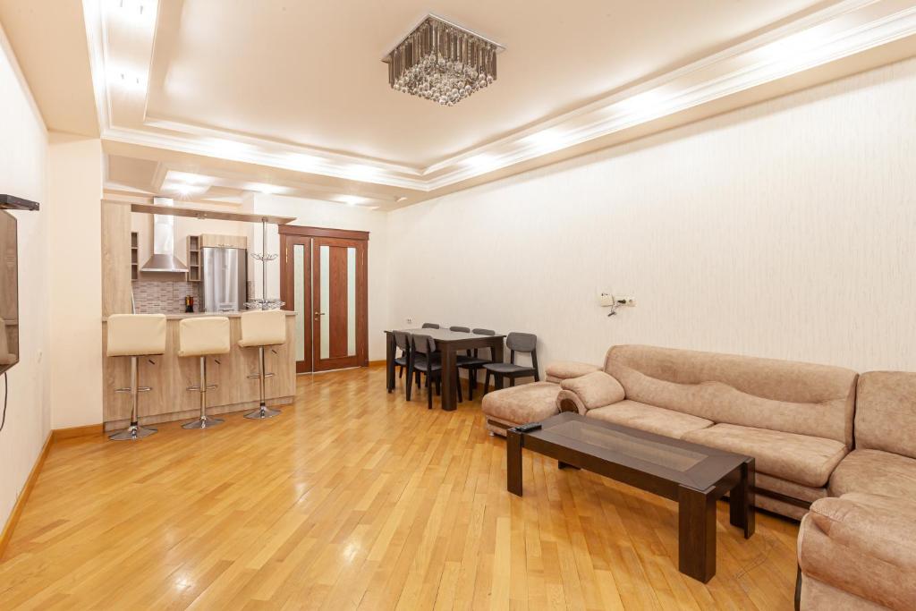 a living room with a couch and a table at Stay Inn apartments at Buzand 13 street in Yerevan