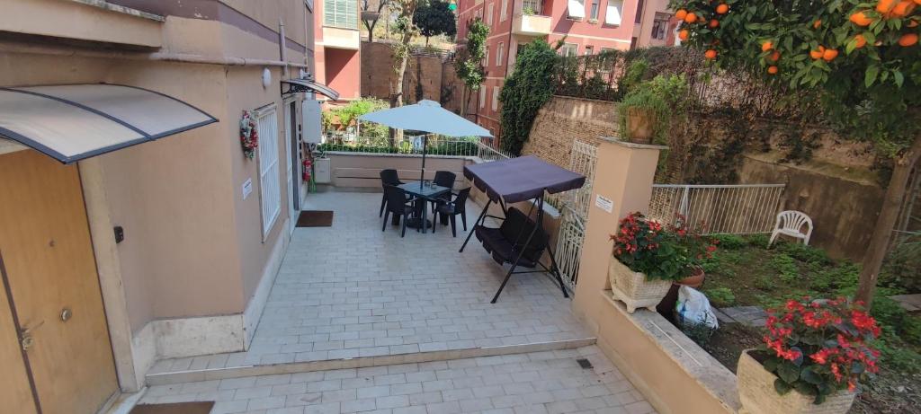 a patio with a table and chairs and an umbrella at VATICAN GREEN GARDEN in Rome