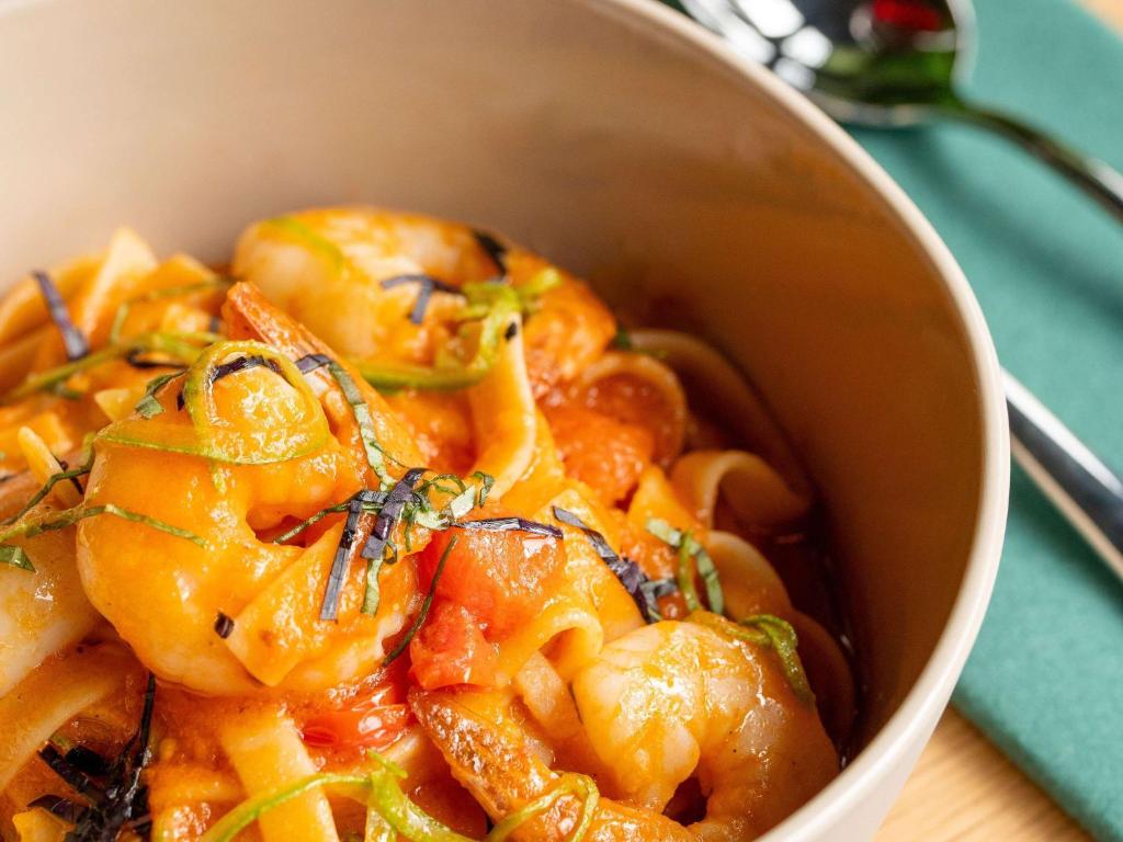 a bowl of food with shrimp on a table at Novotel Istanbul Bosphorus Hotel in Istanbul