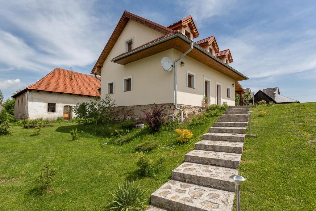 ein Haus auf einem Hügel mit einer Treppe davor in der Unterkunft Villa Lypche in Bešeňová