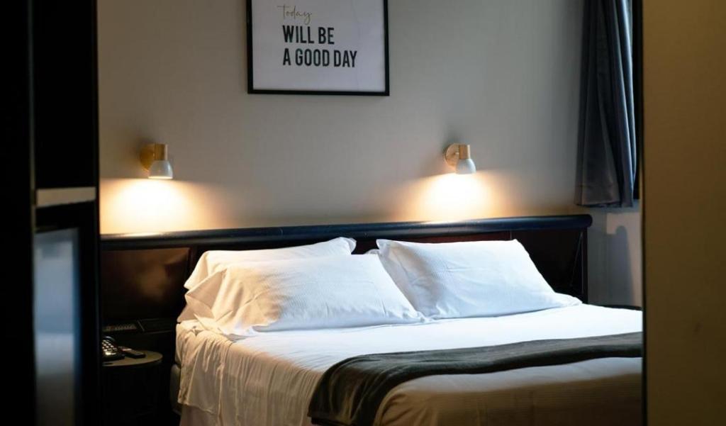 Postel nebo postele na pokoji v ubytování Hotel Concorde
