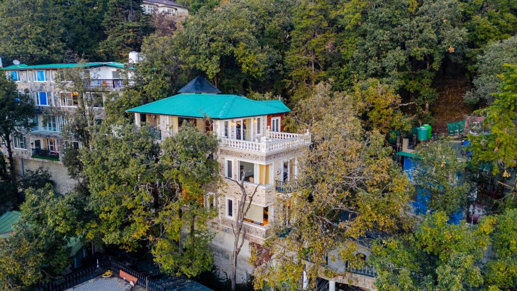an aerial view of a mansion with a blue roof at SaffronStays Naiintara in Nainital