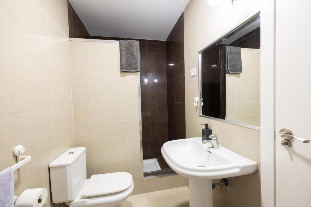 a small bathroom with a toilet and a sink at Kite & Surf Nomad House in Las Palmas de Gran Canaria