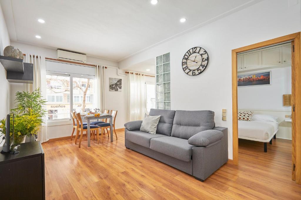 a living room with a couch and a table at BBarcelona Gràcia Nova Flat in Barcelona