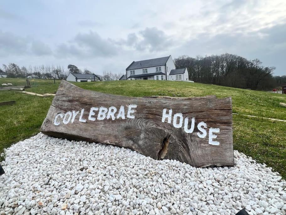 a log with the words cooperative house written on it at Coylebrae House in Ayr