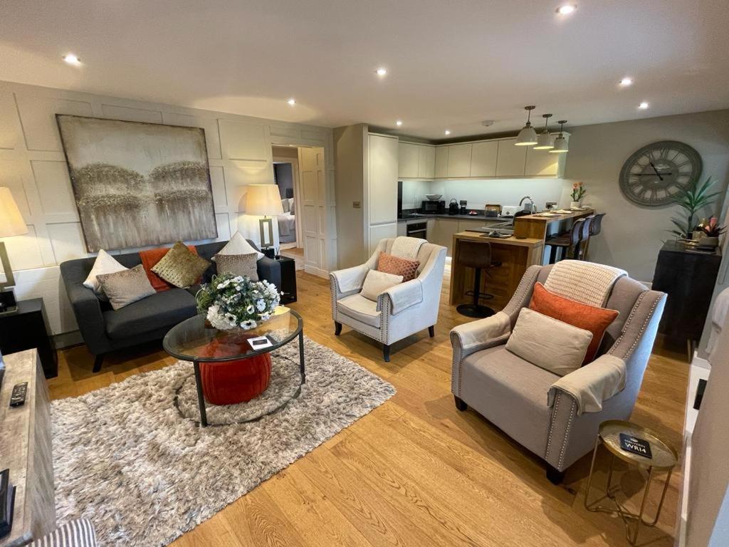 a living room with a couch and chairs and a kitchen at #8 Brunel House Luxury Apartment in Great Malvern in Great Malvern