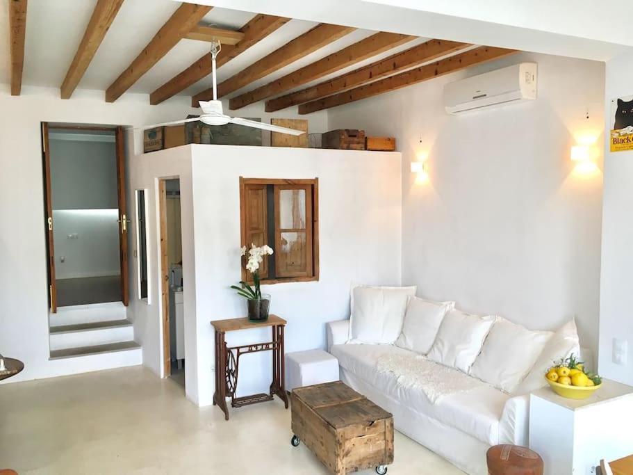 a living room with a white couch and a table at casita limon in Palma de Mallorca