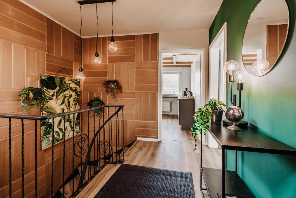 a hallway with wood paneling and a mirror at Happy Platz mit Sauna, Flair & Platz für große Familien in Plettenberg