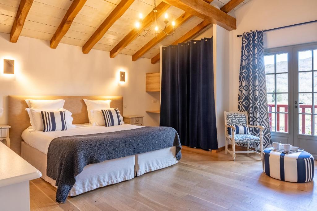 a bedroom with a large bed in a room at Hotel La Maison Oppoca in Aïnhoa