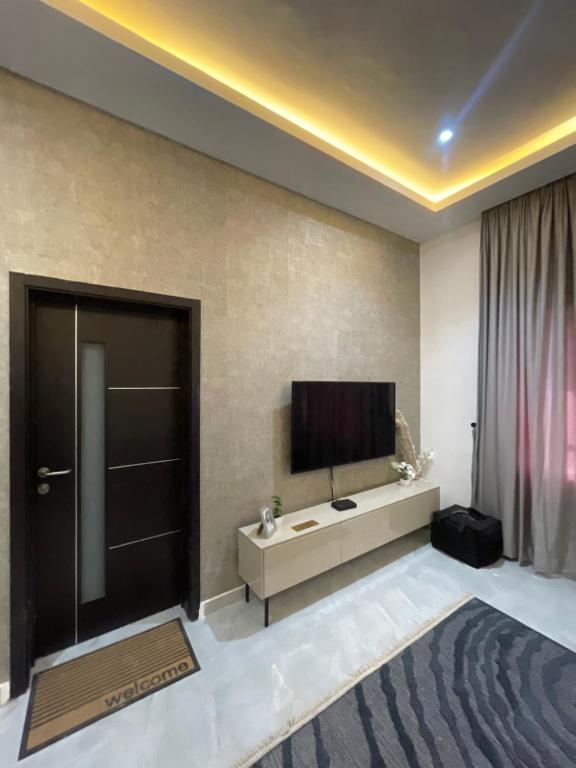 a hotel room with a television and a large room at Luxury Airport residential in Accra