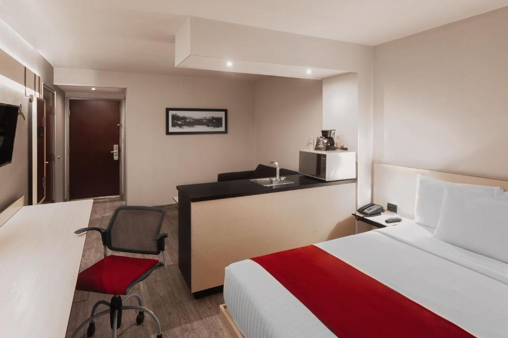 Postel nebo postele na pokoji v ubytování City Express by Marriott Leon