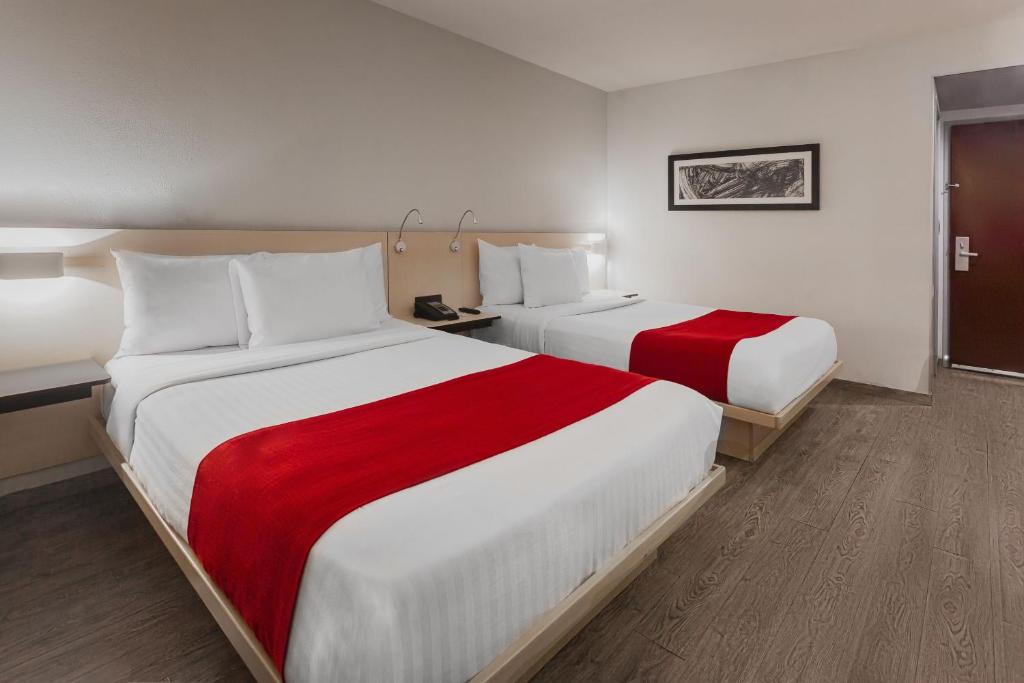 Postel nebo postele na pokoji v ubytování City Express by Marriott Leon