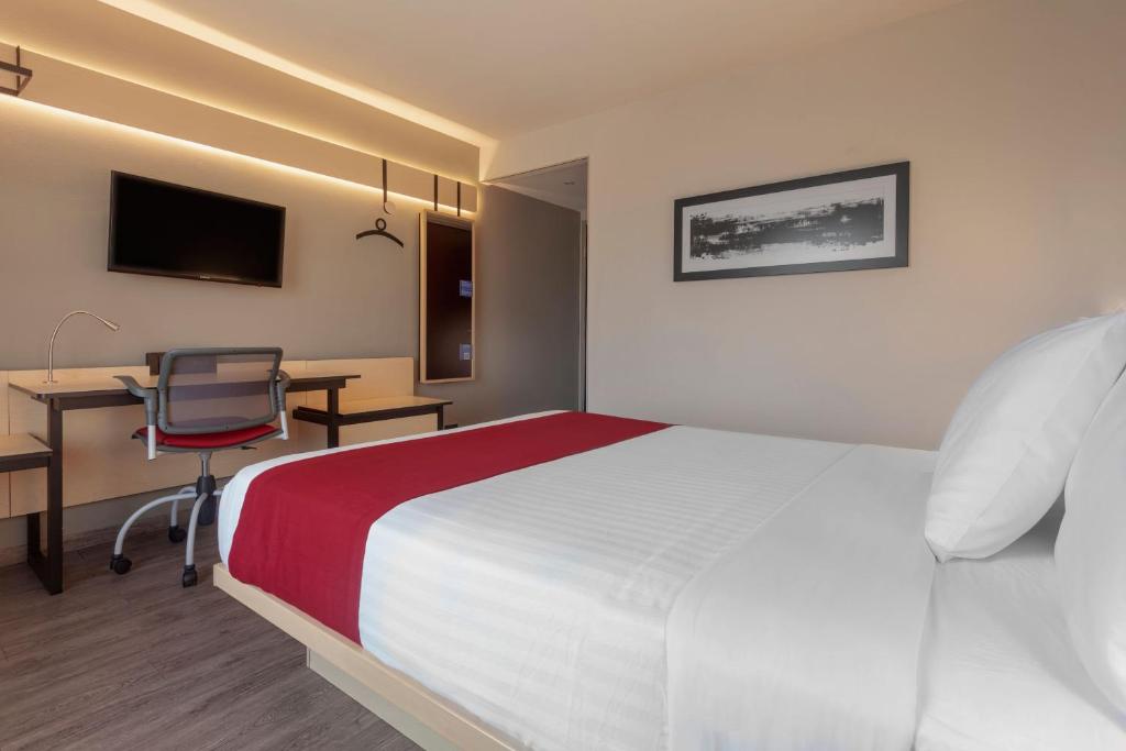 TV a/nebo společenská místnost v ubytování City Express by Marriott Leon