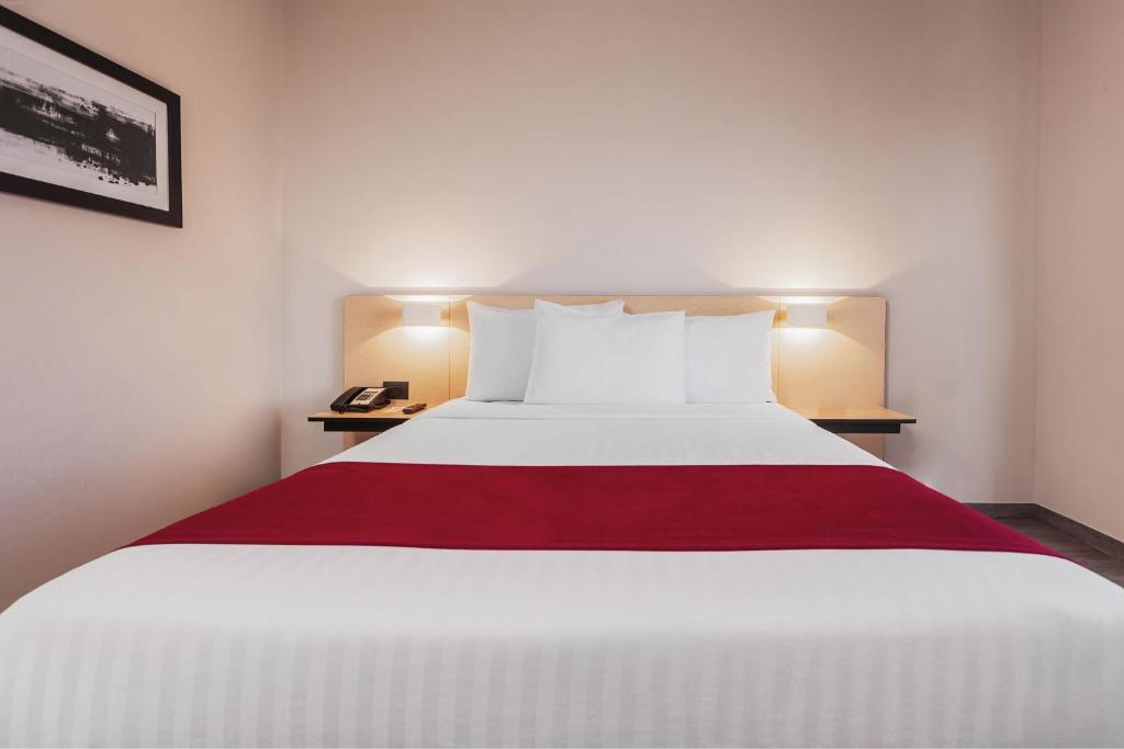 Postel nebo postele na pokoji v ubytování City Express by Marriott Leon