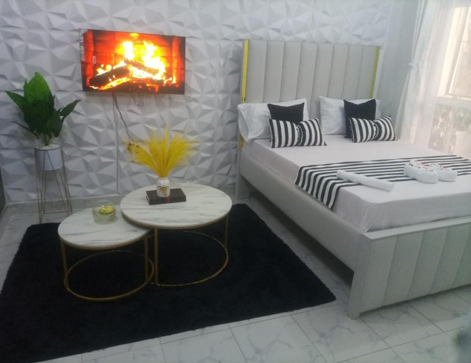 a small room with a bed and a table at Stylish villa homes in Mombasa