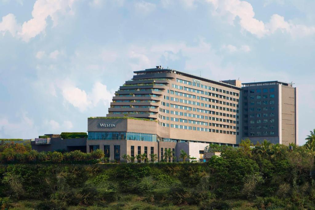 a large building with a sign on top of it at The Westin Pune Koregaon Park in Pune