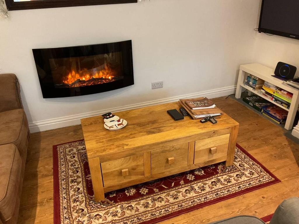 a living room with a coffee table and a fireplace at Brewers Den a Beautiful 1-Bed Apartment in Masham in Ripon