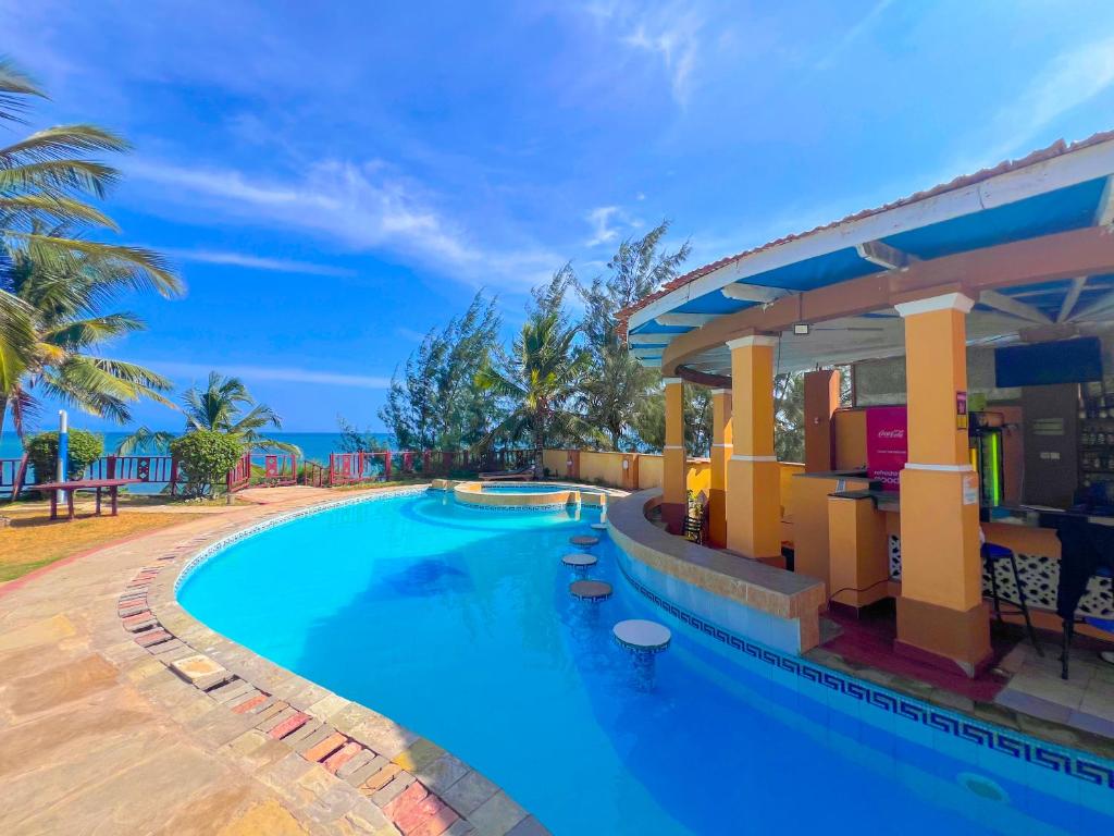 an image of a swimming pool at a resort at Shanzu Reef Beachfront Apartments in Mombasa