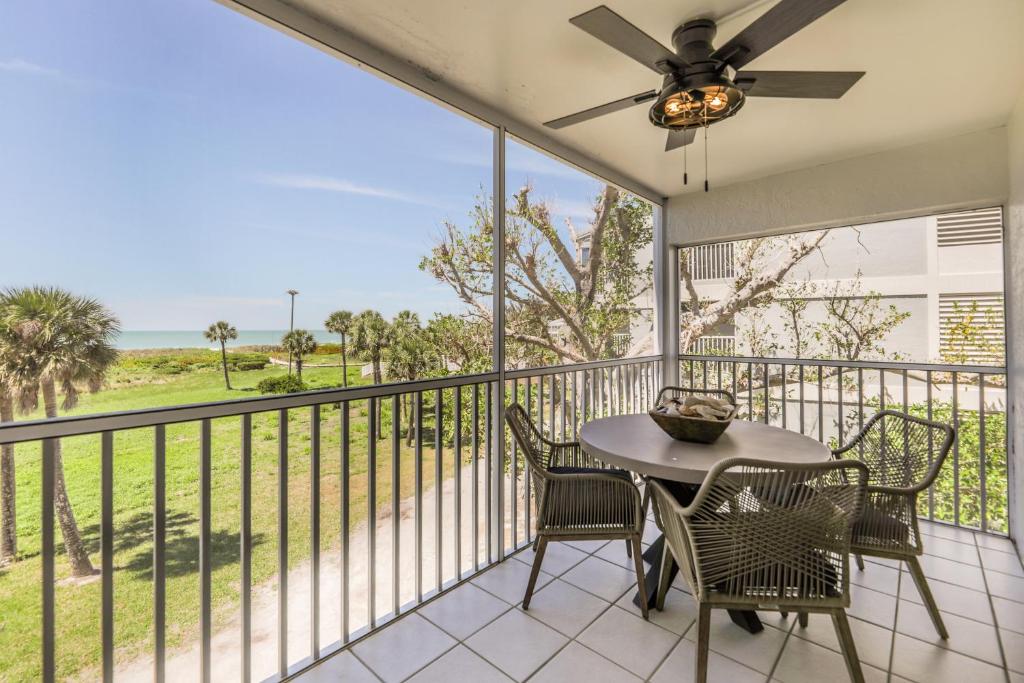 a balcony with a table and chairs and a view of the ocean at SOUTH SEAS BEACH VILLA 2428 in Captiva