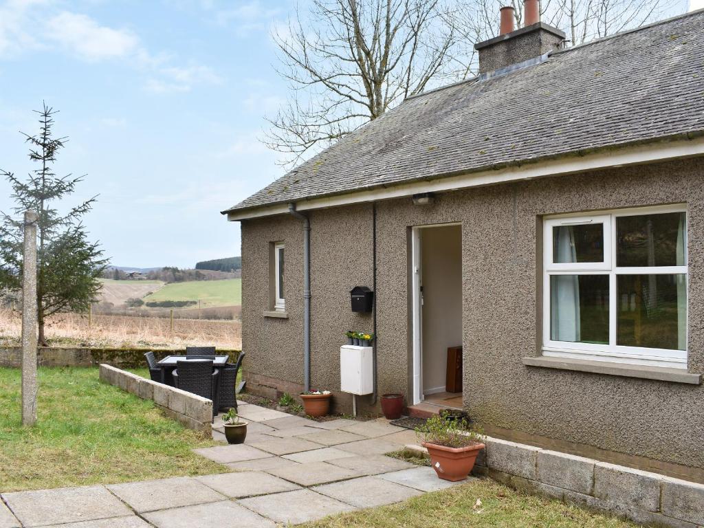 a small house with a patio outside of it at Mains Of Asloun Two - Uk44788 in Alford