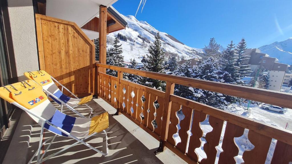une chaise sur un balcon avec une montagne enneigée dans l'établissement Eperon 2 - F4 - Studio lumineux - 6 pers, à Les Deux Alpes