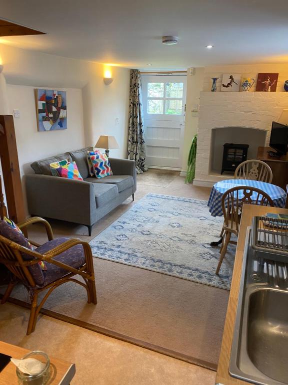 a living room with a couch and a fireplace at The Barn @ Bishops Lydeard in Taunton
