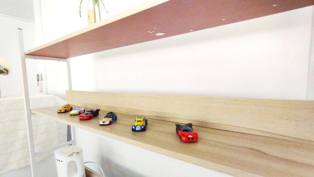 a shelf with toy cars on it in a bathroom at NK hostel P2 16/30 in Ban Song Hong