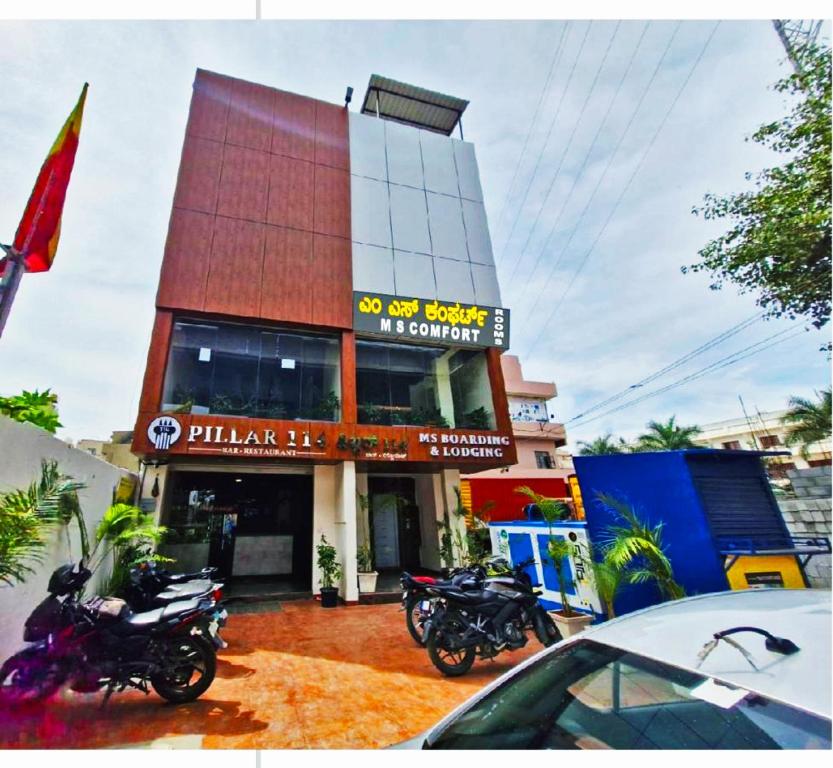 a building with motorcycles parked in front of it at MS Comforts Mahadevapura in Bangalore