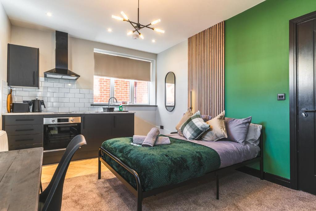 Stunning Central Derby Apartment Free WiFi & Parking في ديربي: غرفة معيشة مع أريكة في مطبخ