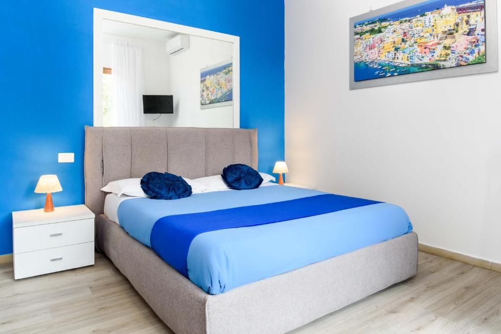 a blue bedroom with a large bed with blue pillows at Estate4home - Casa Laura in Sant'Agnello