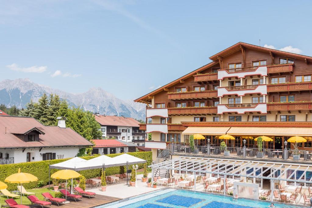 a hotel with a swimming pool and a resort at Alpenpark Resort Superior in Seefeld in Tirol
