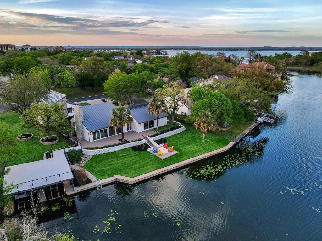an aerial view of a house on the water at 101 On The Point - Concierge Services in Horseshoe Bay