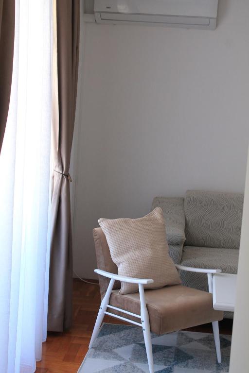 a living room with a chair and a couch at Apartment GeoMo in Mostar