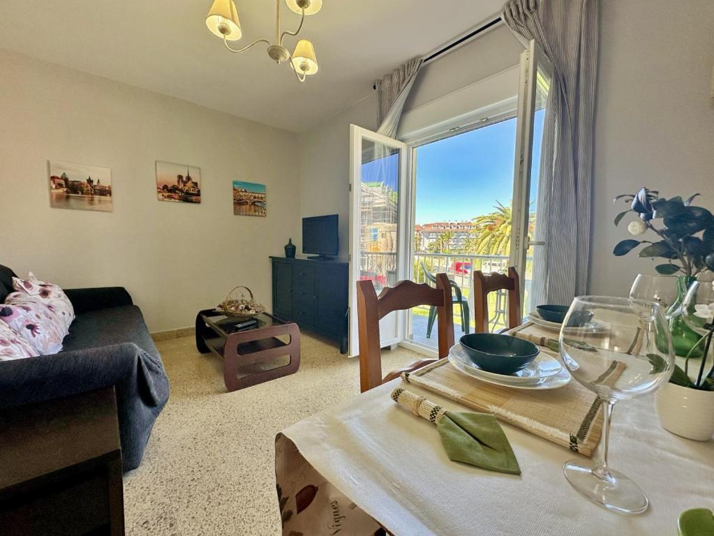 a living room with a dining room table with a view at La Esteluca - 6805 in Noja