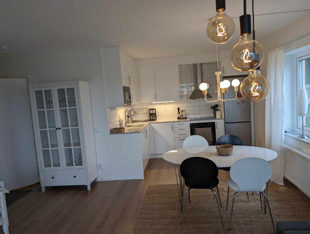 a kitchen with a table and chairs in a room at Central apartment with a view in Växjö