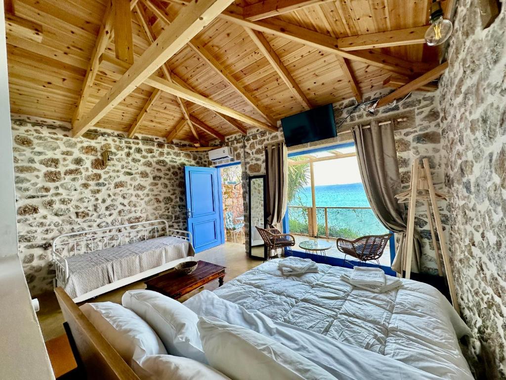 a bedroom with a bed and a stone wall at Rocksecret Edge in Kalamata