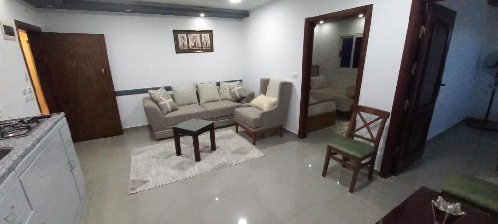 a living room with a couch and a table at Premium apartment in Mansoura