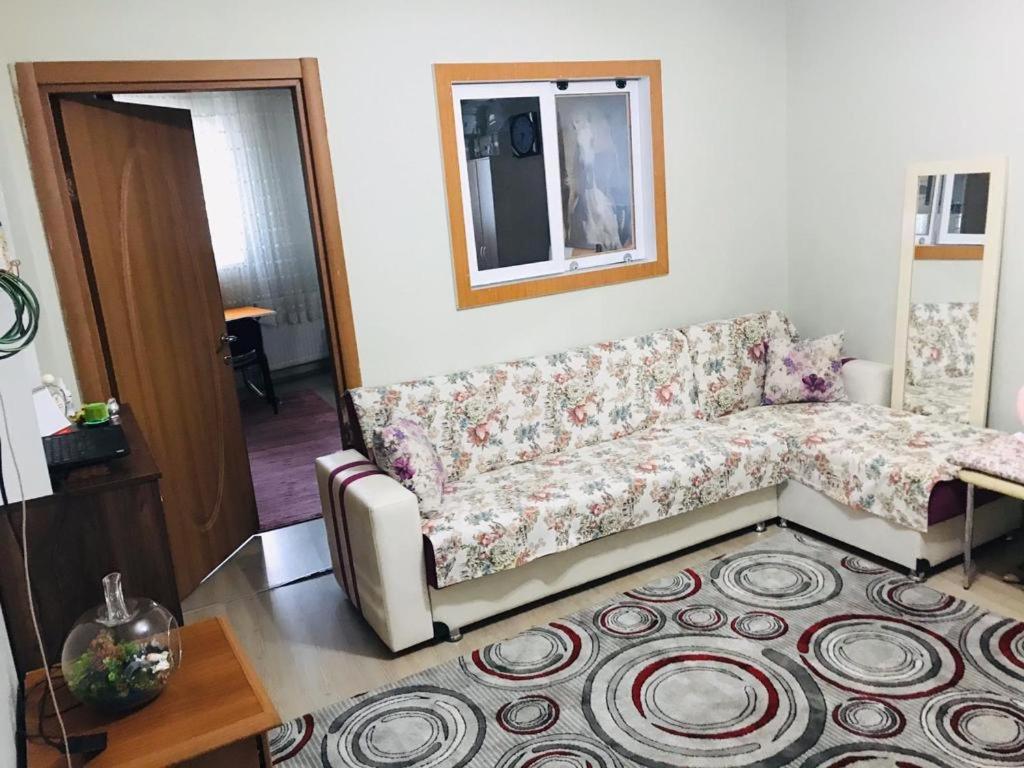 a living room with a couch and a rug at Ortadoğu apart otel in Agrı