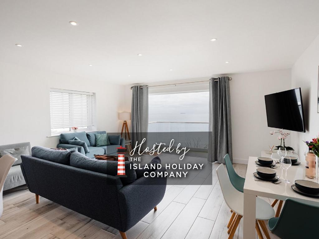 a living room with a couch and a table at The Bay in Sandown