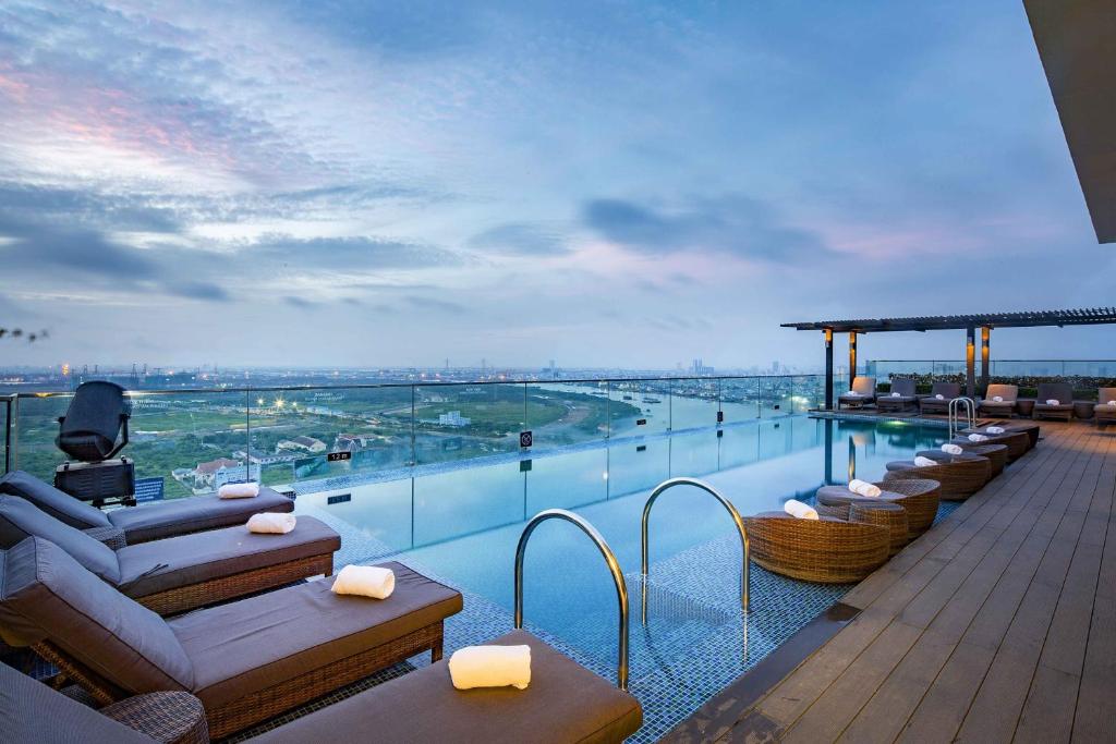 a hotel balcony with a view of a river at Liberty Central Saigon Riverside Hotel in Ho Chi Minh City