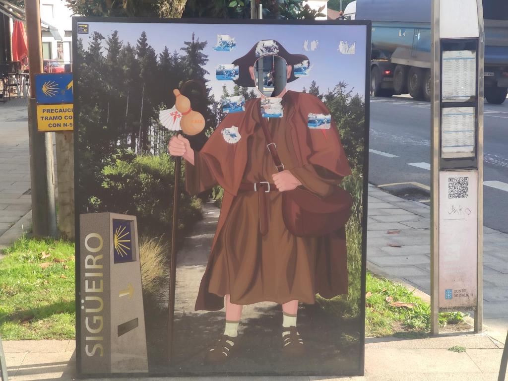 a poster of a person in a costume at a bus stop at PISO OROSO NO CAMIÑO in Sigüeiro