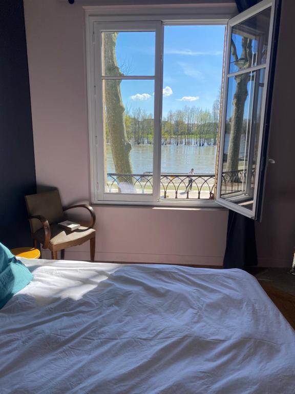 a bedroom with a window with a view of the water at 50 m2 Vue Loire avec parking in Orléans